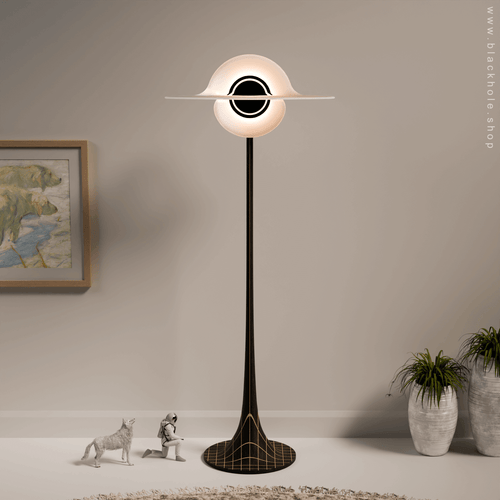 A Black Hole shaped floor lamp with a wooden sculptural stand, emitting warm white light. Wood stand features a stretched spacetime fabric pattern. 