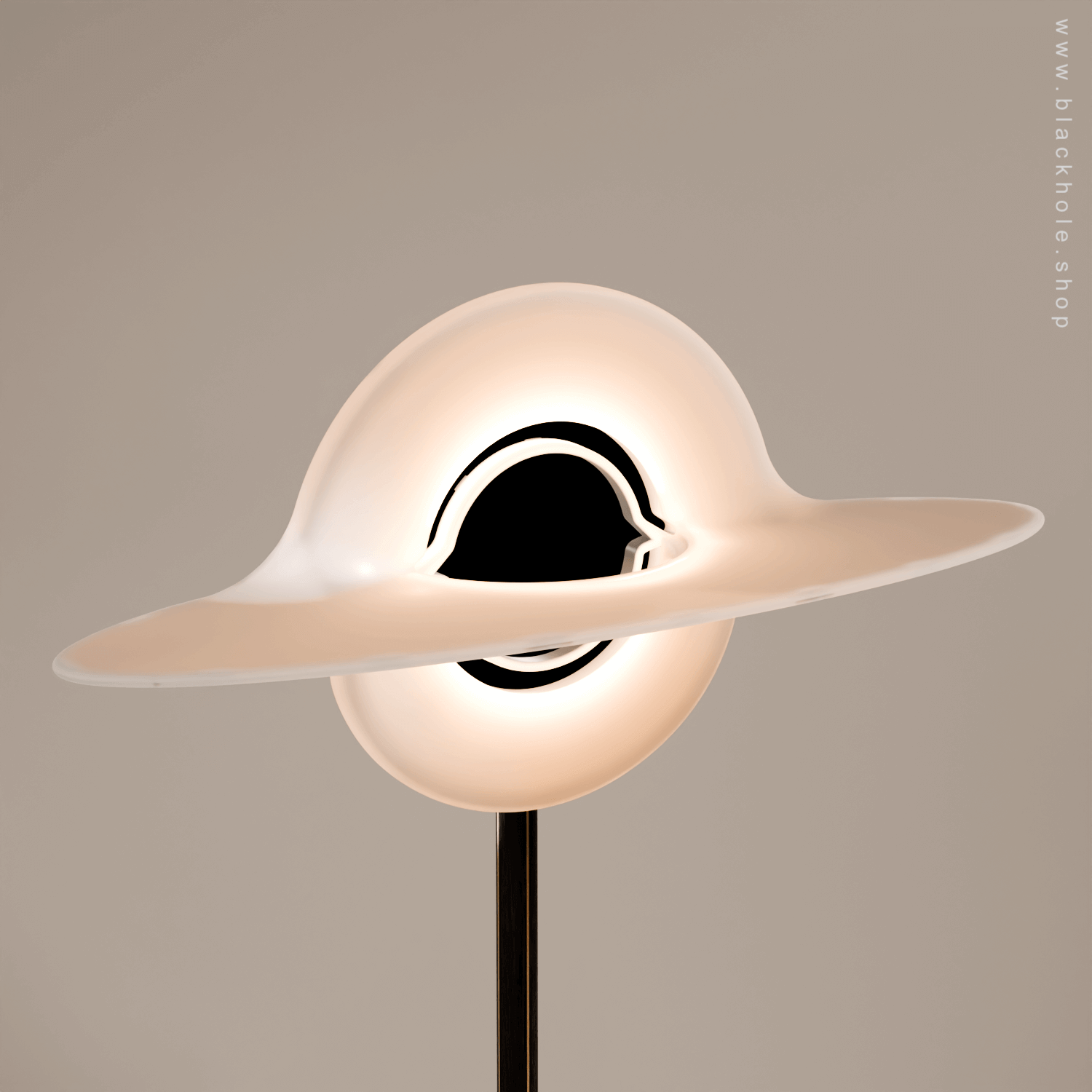 A Black Hole shaped floor lamp with a wooden sculptural stand, emitting warm white light. Wood stand features a stretched spacetime fabric pattern. 