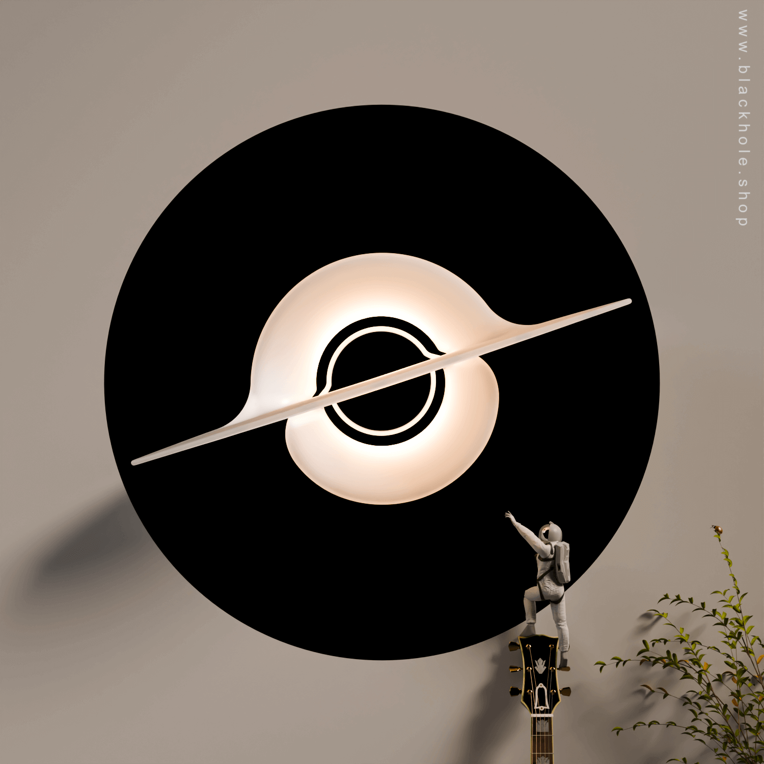 A Black Hole shaped wall lamp mounted on a wall & emitting warm white light.